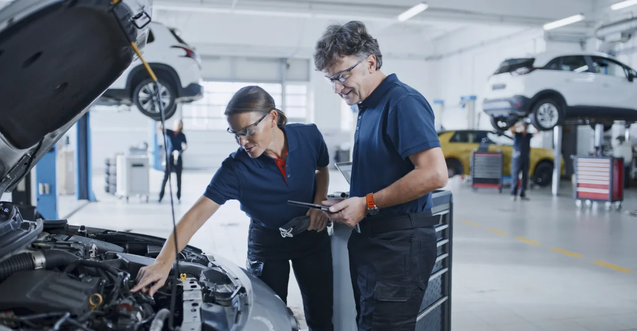 mechanics working in auto body shop